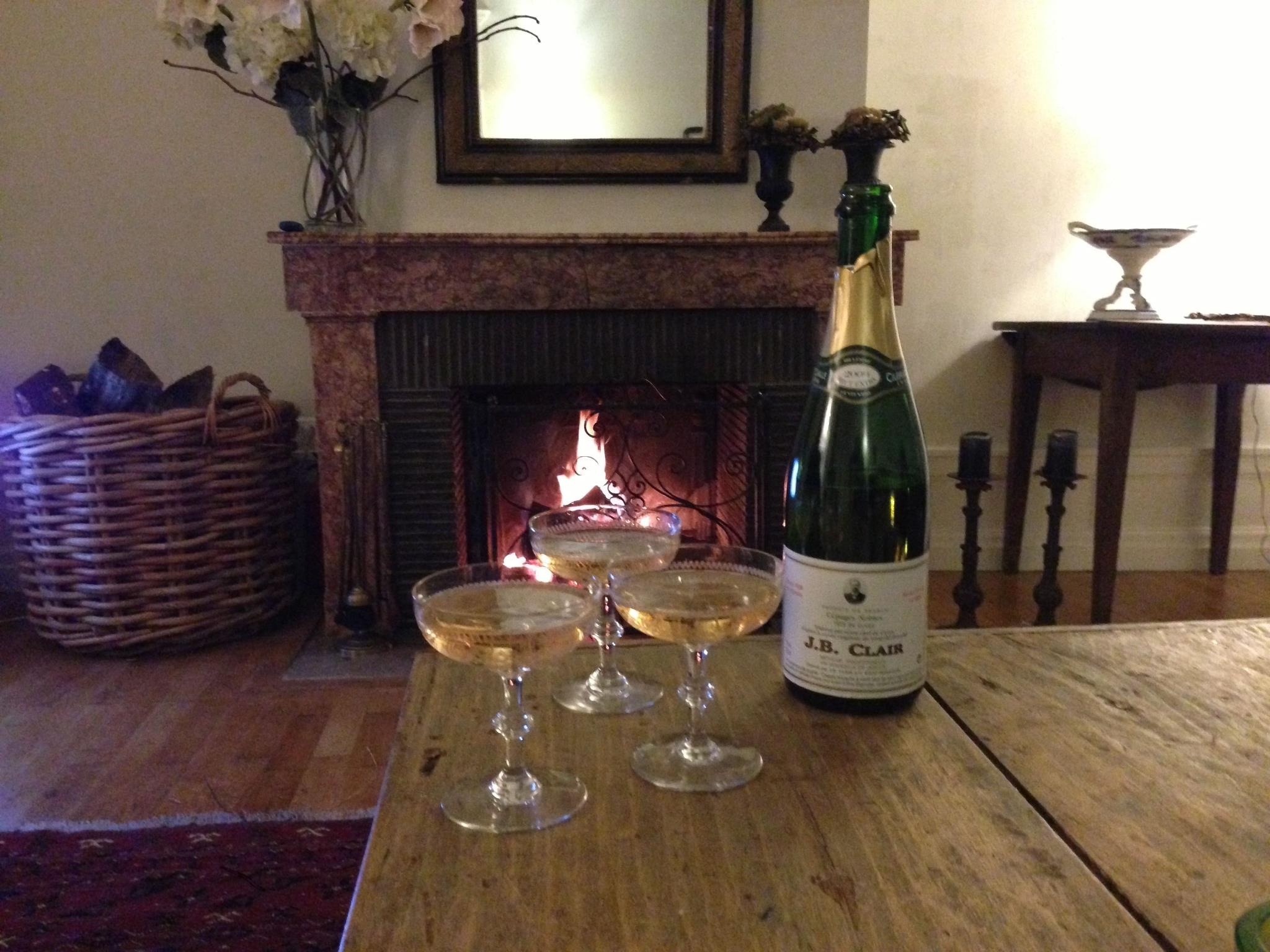 Log fire at Maison Les Bardons en enjoying champagne from J.b. Clair